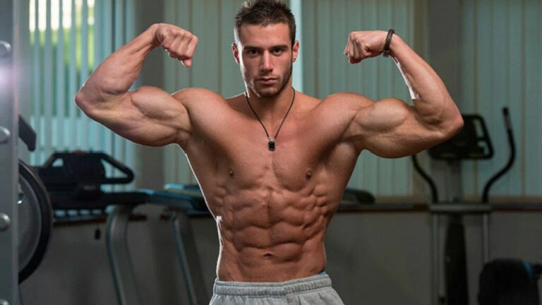 Bodybuilder flexing muscles in a gym.
